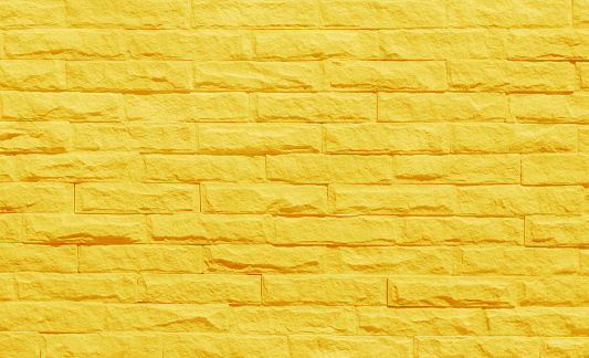 Golden yellow brick wall texture with vintage style pattern for background and design art work.