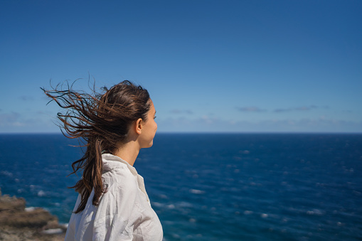 Wind blows her hair, from elevated viewpoint