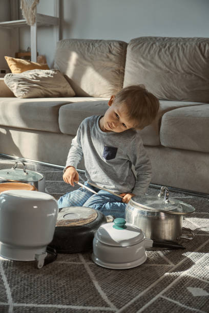 istock Child drummer having fun drum playing on kitchen pans at home 1385153697