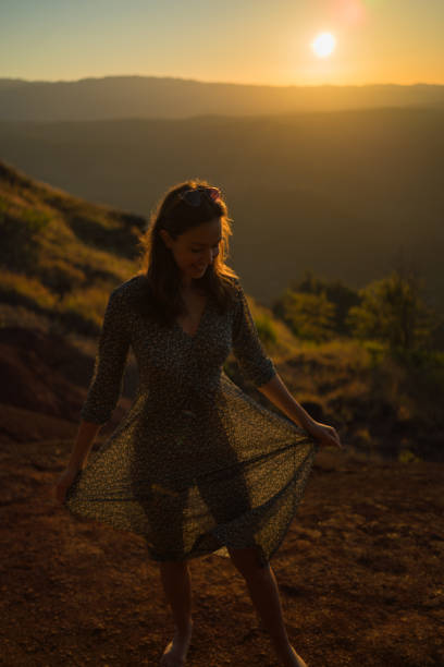 istock Female hiker relaxes on mountain ridge at sunrise 1385153819