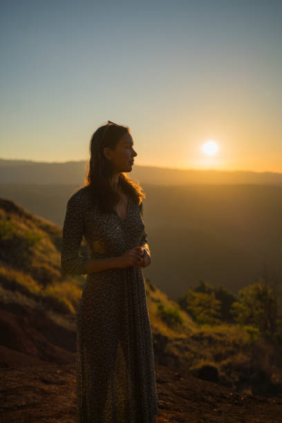 istock Female hiker relaxes on mountain ridge at sunrise 1385153821