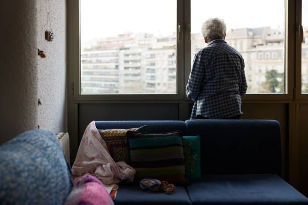 One senior woman looking out the window.