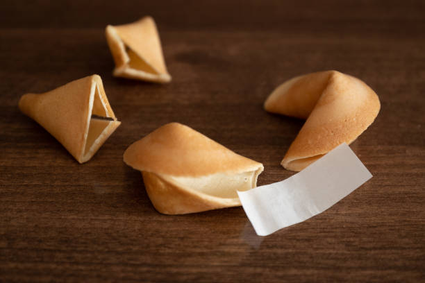 dos galletas de la fortuna y papel en blanco para su deseo buena suerte en la superficie de la mesa - luck fortune telling cookie fortune cookie fotografías e imágenes de stock