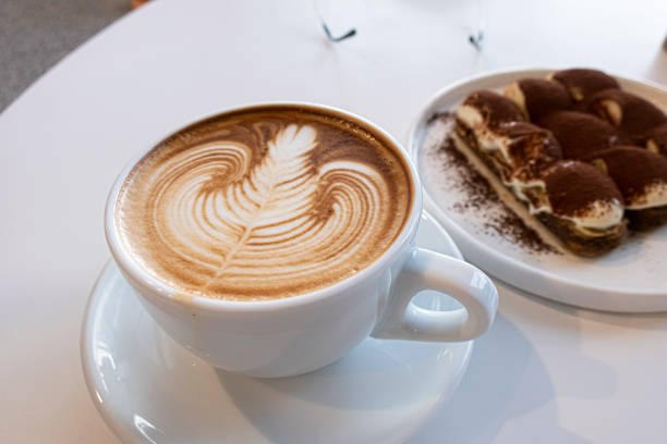 Coffee cup of rosetta latte art on white background isolated