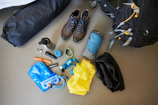 Items such as hiking shoes, water bottle, pocket knife or headlamp for a hiking or trekking holiday, high resolution with copy space