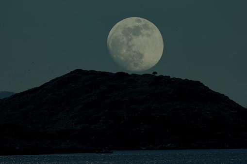 Beautiful night view of sea, mountain and moon