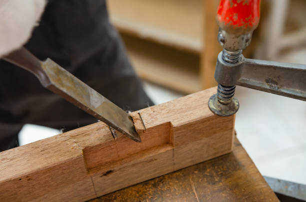 istock Young man doing woodworking hobby in his workshop, soft focus. 1385155965