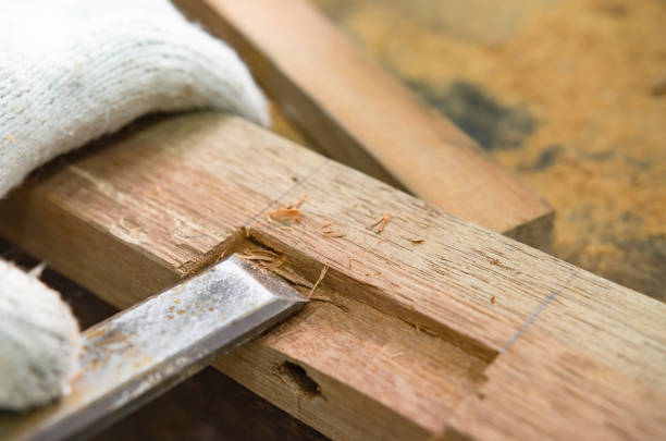 istock Young man doing woodworking hobby in his workshop, soft focus. 1385156017