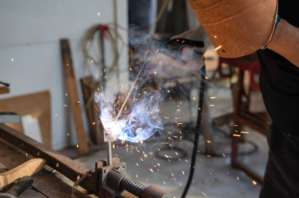 istock young man doing hobbies welding steel in his workshop Soft focus 1385156040