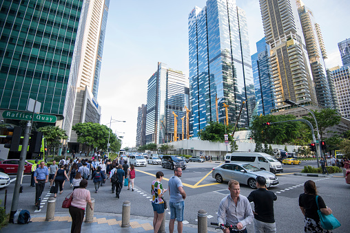 Singapore City, Singapore - September 08, 2019: People are crossing the crossroads on the streets of the Central Business District.