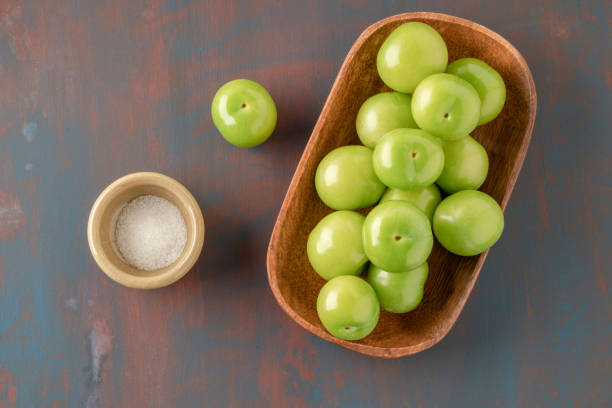 istock fresh ripe green plum fruits and salt on table 1385156484