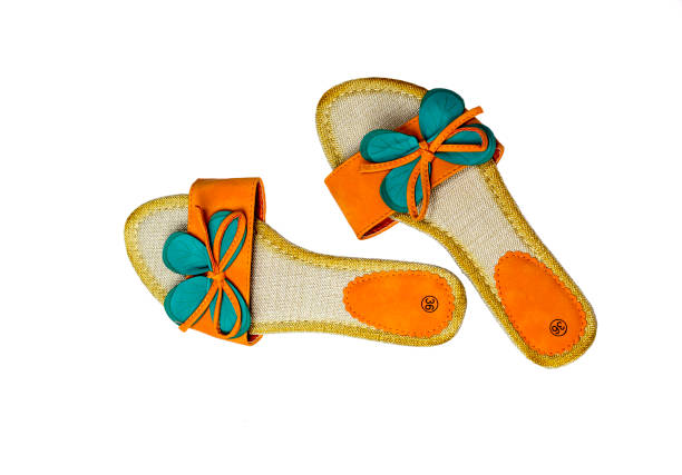 New, modern, comfortable, women's, orange sandals on a white background close-up