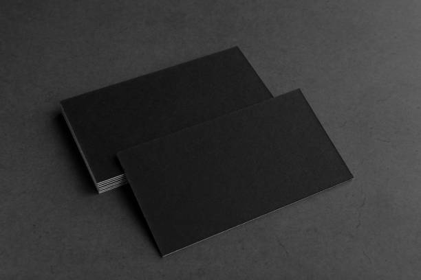 istock Business card on black background. 1385159959