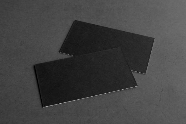 istock Business card on black background. 1385159960