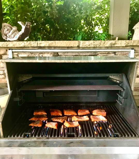istock Fish cooking on a grill outdoors 1385162915