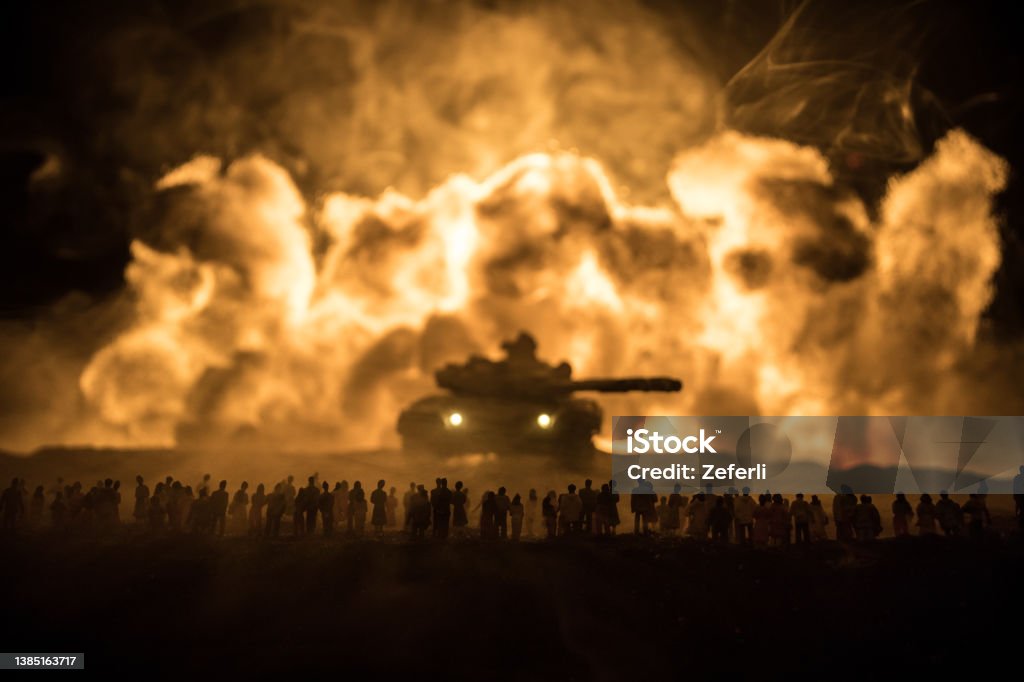 Creative artwork decoration war on Ukraine. Crowd looking on giant explosion and attacking soldiers. Creative artwork decoration - Russian war in Ukraine concept. Crowd looking on giant explosion and attacking armored vehicles. Selective focus War Stock Photo