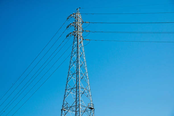 istock Electric Pole Power Lines And Wires With Blue Sky Background 1385164073