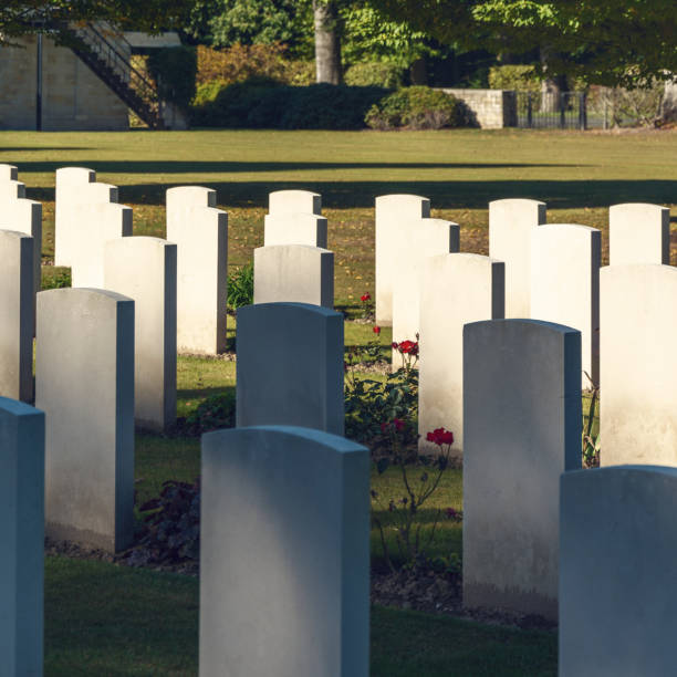 istock cemetery with white graves on green grass in the autumn sun 1385164146