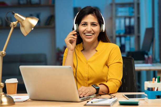istock female call center operator in headset talking with customer, stock photo 1385164414