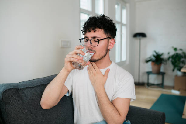 istock Young Caucasian man feeling sick at home 1385165040