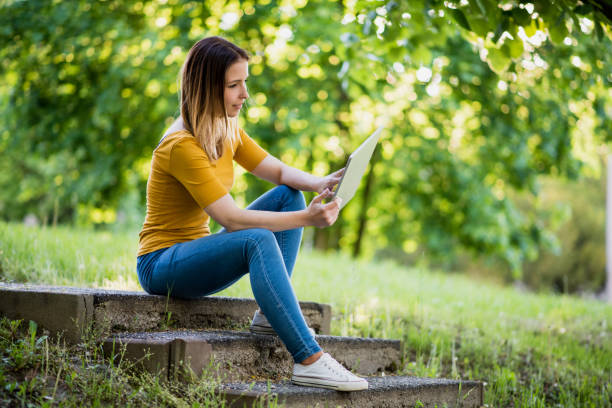 istock women using digital tablet in city 1385165788