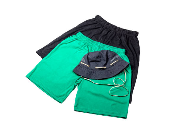 istock Men's shorts and cap on a white background close-up 1385165861