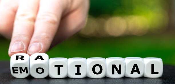 istock Hand turns dice and changes the word emotional to rational. 1385167714