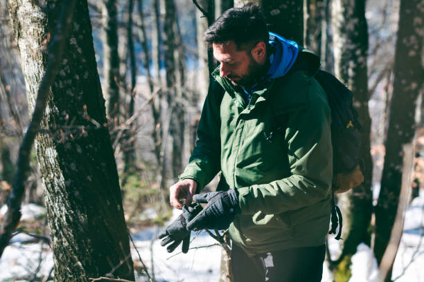 istock Man hiking mountain forest in late winter 1385168341