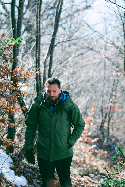 istock Man hiking mountain forest in late winter 1385168357