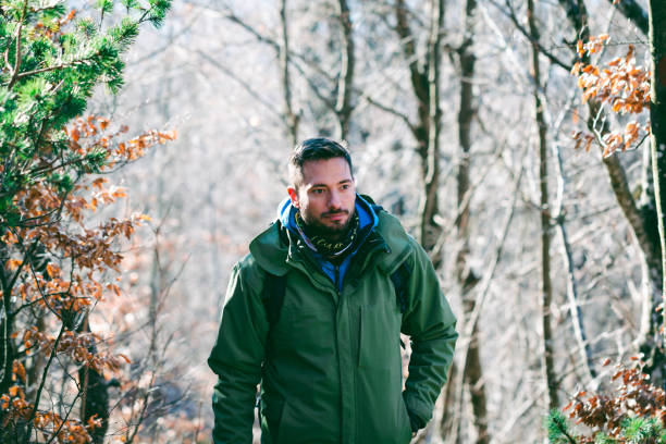 istock Man hiking mountain forest in late winter 1385168378