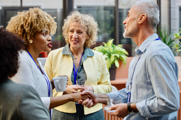 istock Conference speakers handshaking after presentation at the convention center 1385168392