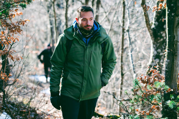 istock Man hiking mountain forest in late winter 1385168429