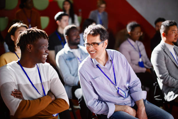 istock Businesspeople laughing and talking in between breaks during  conference event 1385168537