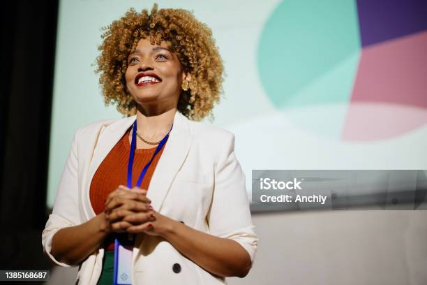 Close Up Of A Visionary Female Speaker Smiling And Looking At The Audience Stock Photo - Download Image Now