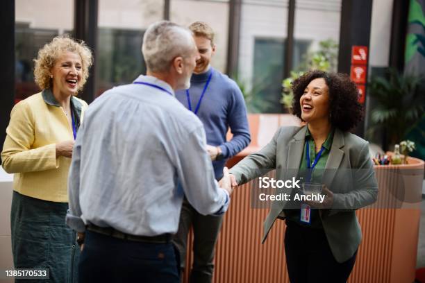 Business People Greet Each Other During A Coffee Break At A Conference Stock Photo - Download Image Now