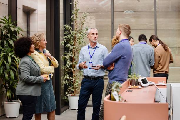 istock Business people enjoying conversation with diverse colleagues during break from conference 1385170554