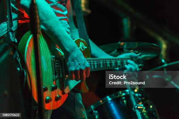 The Guitarist Plays On Guitar In A Dark Room Hands Of A Guitar Player Playing The Guitar Low Key Stock Photo - Download Image Now