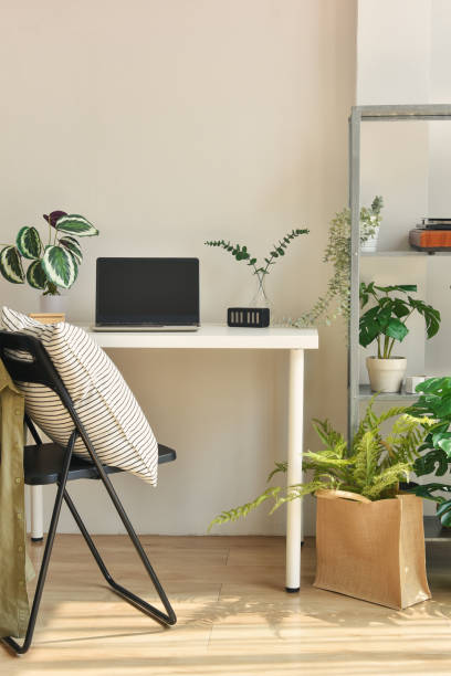 istock Home office decorate with green nature tree plants, Workspace and laptop computer on desk, Artificial houseplant for home and living room interior. 1385170655