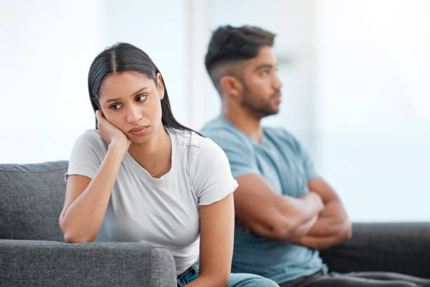 Shot of a young couple sitting on the sofa at home and ignoring each other after a fight I'm not happy at all arguing stock pictures, royalty-free photos & images