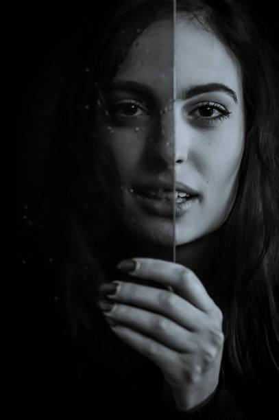istock Aging Process - Beautiful long haired young woman holding a glass plate covered with droplets in front of her face, imperfections that come with time 1385175496