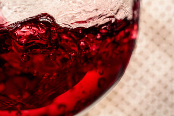 istock Red wine is poured into a glass. 1385176161