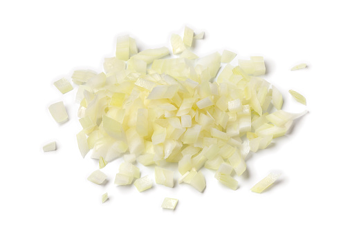 Heap of fresh cut white raw onions on white background close up