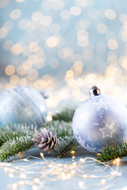 istock Christmas spruce with ball and blurred shiny lights. 1385176504