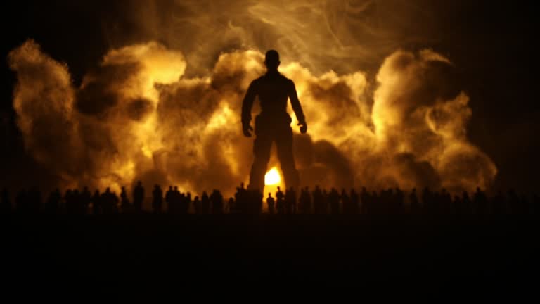 Creative artwork decoration - Russian war in Ukraine concept. Crowd looking on giant explosion and silhouette of giant person. Selective focus