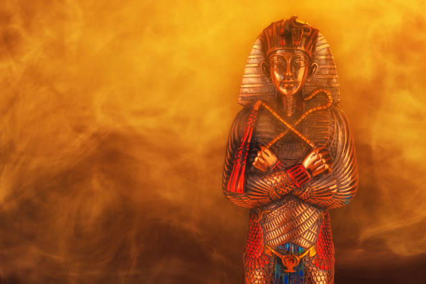 Egyptian pharaoh figurine in yellow smoke on a black background. side view