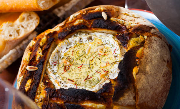 istock Cheese fondue from camembert in bread bowl 1385181379