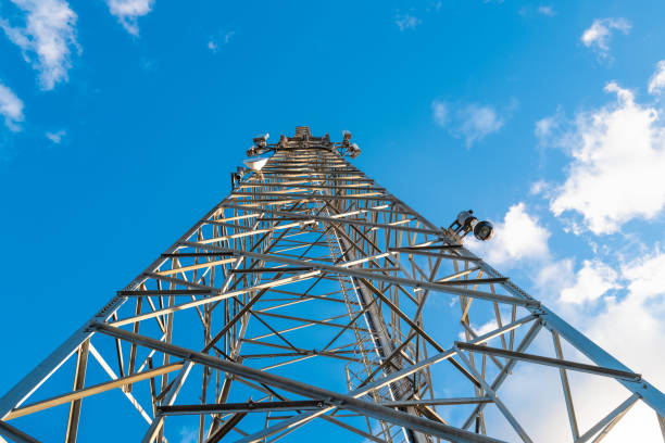 istock Vertical view of a communications tower showing installed multi-services  telecom equipment including Microwave and 5G cellular repeaters. 1385183535