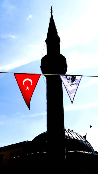 A silhouette of a minaret A silhouette of a minaret with a Turkish flag and a pennant of Ataturk pennant bannerfish photos stock pictures, royalty-free photos & images