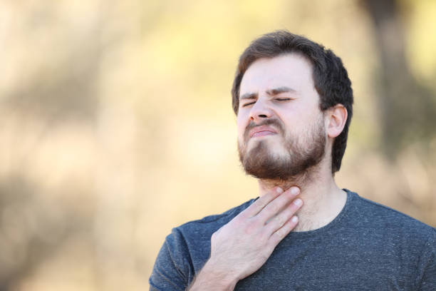 istock Man suffering sore throat in nature 1385186831