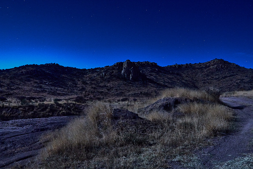 Mountains under the moonlight with a dark sky and few stars, western-like scene in the city of Durango Mexico